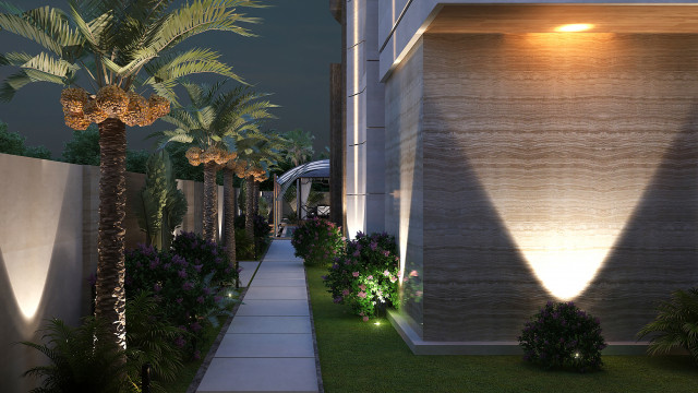A lush, tropical garden and pool surrounded by lush vegetation and illuminated pathways.