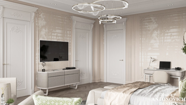 This picture shows a luxurious modern bedroom with a statement art piece on the wall. The bed is upholstered in velvet grey and adorned with many pillows for comfort and style. There is a matching grey armchair in one corner and a round coffee table in the other with a glass top. The walls are white and the floor is tiled with a geometric pattern. The art piece is a large, abstract oil painting in shades of pink and purple, adding a bold touch to the otherwise neutral decor.