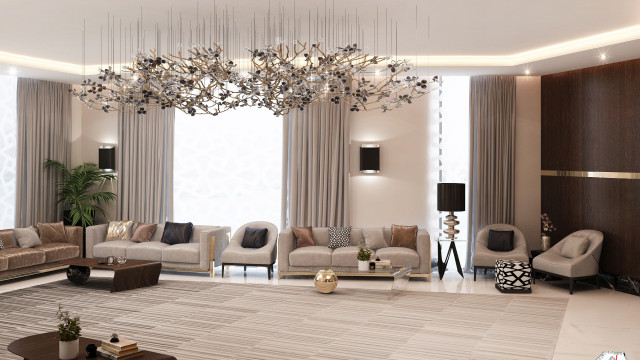 This picture is of a luxurious modern open plan living room. It features a light grey cream and tan color scheme, with ivory hardwood flooring throughout. There are two beige velvet sofas on either side of the room, complemented by a glass top coffee table in centre. There is a large dining table with six chairs, as well as several armchairs and accent chairs throughout. In addition, there is a large contemporary fireplace with mantel, surrounded by built-in shelves, which have been decorated with sculptures and artwork. The walls in the room feature light grey paneling