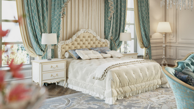 This picture shows an ornately decorated dining room with a classic, modern aesthetic. The furniture is upholstered in ivory and gold accents and the walls are painted in a subtle beige color. The room is illuminated by an elegant chandelier, and the walls feature framed artwork and decorative accents. The floors are covered in a classic hardwood, and the overall effect of the room is warm and inviting.