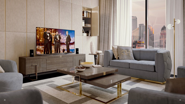 This picture depicts a luxurious living room designed by Antonovich Design. The room features warm, neutral colors and modern, geometric furniture. The walls are painted in a light cream color, while the carpet and drapes have been coordinated to match the color of the furniture. There is also a marble fireplace in the corner of the room, adding a touch of elegance. The room is well-lit with large windows and floor-to-ceiling curtains. Finally, decorative accents like a large chandelier and artwork add a sophisticated finish to the overall design.