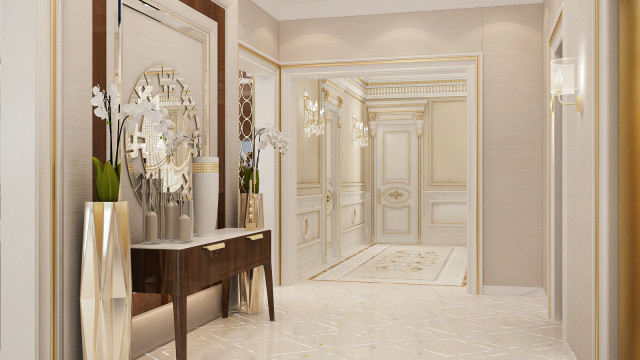 This picture shows a luxurious white and gold bedroom designed by Antonovich Design. The walls are white with intricate gold patterned designs running through them. The room has a large, ornate four-poster bed with white and gold sheets and pillow covers, a padded headboard with gold buttons and trim, and thick patterned curtains. On the nightstands are luxe lamps with elegant gold bases. A plush white rug covers the floor, adding to the luxurious feel of the room. A textured wall mirror completes the look.