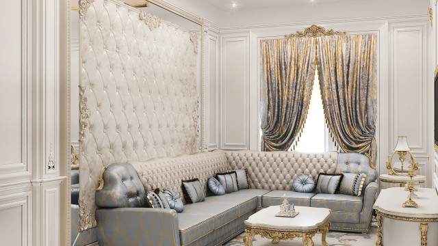 A luxurious bedroom with a king size bed in the center. The walls, shelves, and table are decorated with hand selected furniture and accessories in a gold and white color scheme.
