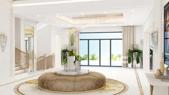 This picture shows an elegant, modern living room interior design. The main color palette is a combination of neutral shades and gold accents. The furniture pieces are upholstered in beige fabric, while the walls are decorated with golden wallpapers. The ceiling features glittering chandeliers, while the floor is covered in light wood. The entire space is illuminated with ambient lighting, giving it a cozy and inviting atmosphere.