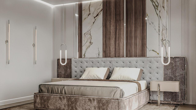 This picture features a luxury modern bedroom. The room is decorated with a patterned wallpaper and a sophisticated canopy bed with upholstered headboard and frame. The bed is accompanied by a chaise lounge, a floor rug, a bench seat and lamps, creating a warm and inviting atmosphere.