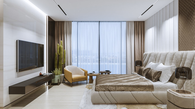 An interior living area featuring an upholstered beige sectional sofa, two armchairs, and a patterned area rug.