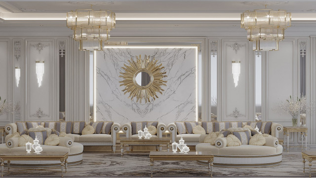 This picture shows a luxurious living room interior in shades of white, gray and gold. The furniture pieces are ornately decorated with gold accents, and an accent wall behind the sofa is highlighted with a geometric pattern in metallic gold. There is a modern fireplace located below the television and a contemporary lighting fixture hanging above the coffee table. In the background, through the large windows, one can see a beautiful outdoor scenery with palm trees and a pool.