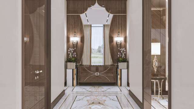 A marble hallway with a curved ceiling and intricately detailed balustrades, complemented by a patterned tiled floor.