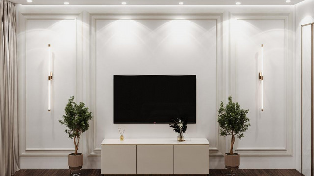 This picture shows a luxury dining room design created by Antonovich Design. It features a grand rectangular table with intricate golden carvings, surrounded by elegant cream-colored chairs decorated with gold accents and fabric tufting. The walls are painted in a warm beige tone, while the flooring is a glossy marble tile with a stylish black and white pattern. There is an ornate gold-framed mirror on one wall, adding a touch of glamour to the space.