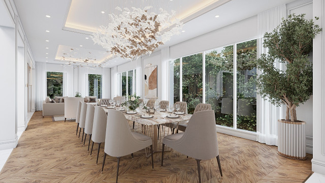 This picture shows a modern office space. The room is open and airy with white and beige walls, a light-colored hardwood floor, and large windows with beautiful views. The furniture is modern, minimalist, and comfortable, and includes a couch, armchairs, and tables. There are also plants and muted artwork throughout the room, creating a calming atmosphere.