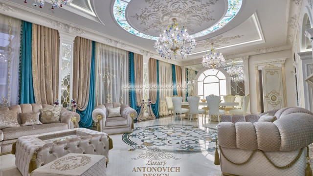 Large room featuring vaulted ceiling with intricate chandelier, decorative mirrors on wall, and grand sofa with side tables.