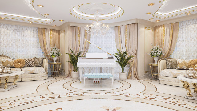 Table setting with various gold-rimmed plates and cups, lit by a chandelier.