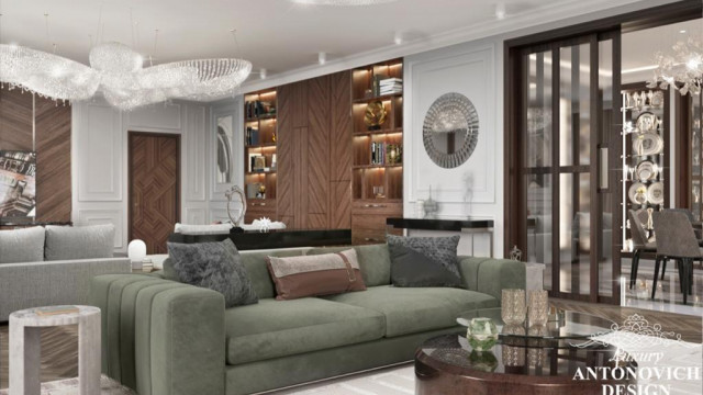 Modern luxury living room featuring a curved beige couch, two armchairs, white marble fireplace, and large round glass window with black curtains.