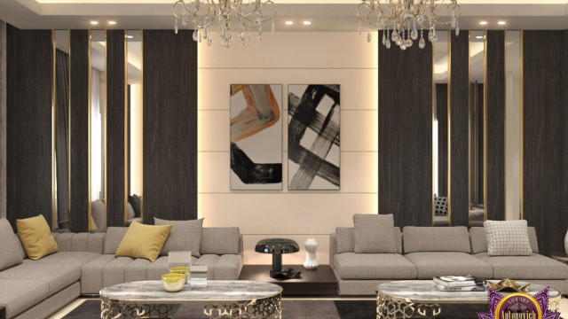 A living room featuring a grey sectional sofa with an accent chair, marble coffee table, and wall art hung above a TV console.