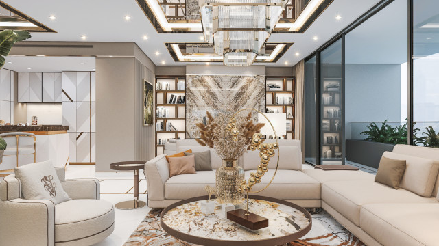 This picture shows a luxurious living room featuring a large, grey sectional sofa set in a U-shaped configuration. The walls are decorated in a light beige color, and the floor is covered with a pale yellow carpet. There are two stylish armchairs in the corner, and the room is accented with several vibrant pieces of artwork. The overall look is modern, sophisticated, and inviting.