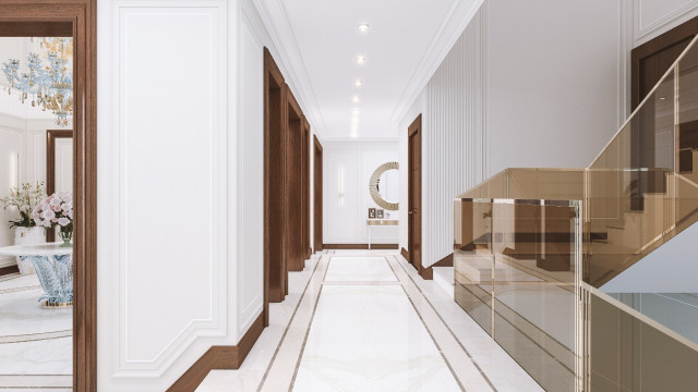 This picture shows a modern and luxurious bathroom interior design. The bathroom features marble floors, a large double vanity with an expansive mirror and golden fixtures, a walk-in shower with a glass door, a separate soaking tub, and high ceilings. The vanity is decorated with white and gold flower vases and a patterned tray. The walls are painted in a warm, neutral white color, and golden sconces are placed on either side of the vanity for additional lighting.