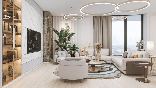 This picture shows an elegant, luxurious bathroom with a marble floor and walls. The walls have intricately-designed molding, and the shower is framed by columns on each side. There is a marble countertop with a sink and a mirror above, as well as a large walk-in shower with a built-in seat. In addition, the ceiling has recessed lighting and the entire room has a warm and inviting feel.