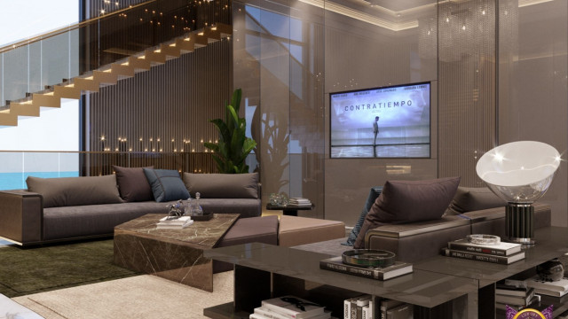 A modern luxury living room with a beige sectional sofa, glass-top center table, round coffee table, and various accent pieces, including an ornate golden mirror, greenery in the corner, and a green and gold rug.