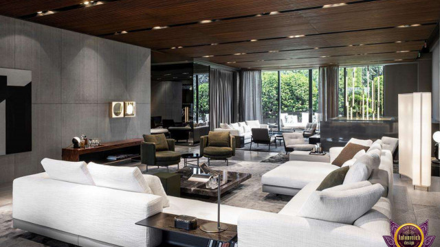 Modern living room with sofa set and coffee table surrounded by patterned carpeting, beige walls, and window curtains.