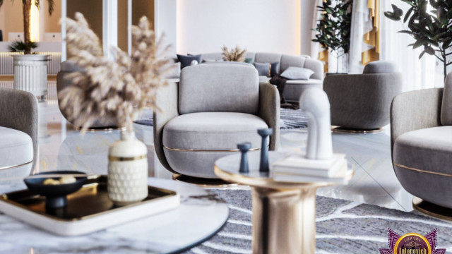 Modern luxury interior design with white armchairs, a light-colored chaise lounge, and a marble coffee table, set atop an ornately patterned rug.
