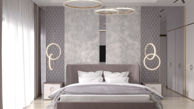 A luxurious bedroom illuminated with a crystal chandelier, decorated with gold details and elegant furniture.