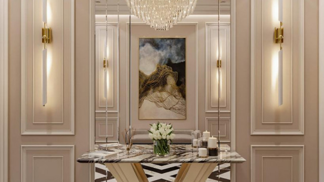 This image depicts an interior design featuring an intricately-patterned ceiling and intricate moldings, a luxurious sectional sofa, and an ivory armchair.