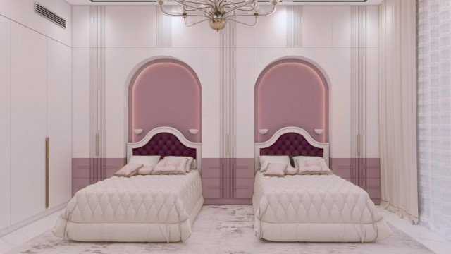 The picture shows a luxurious bedroom with an elegant design. The room is adorned with sheer white curtains and a gorgeous bed frame with intricate details and a tufted headboard. The room also features mirrored furniture, a plush rug, and modern lighting fixtures. A large mirror hangs on one wall, and the other wall is painted with a beautiful wallpaper pattern.