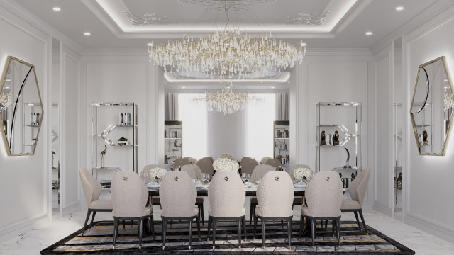 This picture shows a luxurious living space, with a double-sided seating area. There is a black sofa, and two armchairs with white and yellow floral upholstery, arranged in a symmetrical pattern. The room also features ornate gold detailing on the walls, furniture and flooring, as well as a crystal chandelier, and creamy yellow accents. A round glass coffee table sits in the centre of the room, surrounded by Persian-style patterned rugs.