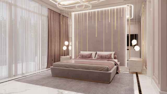 This picture shows an elegantly designed bedroom with luxurious dark wood furniture and a warm neutral color palette. The room features a large bed with a tufted headboard, covered in ivory and tan pillows and throws. To the side of the bed is a bench seating area that is upholstered in a soft silvery-grey fabric. The walls are painted a light beige and are adorned with artwork. A collection of modern lamps and sconces provide lighting to the area.