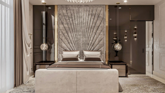 This picture is an example of a luxurious bedroom from Antonovich Design, a design firm based in the United Arab Emirates. The room features a carefully decorated space with a large four-poster bed, two matching nightstands, and a large dresser. The walls have been painted a light beige color, with gold accents throughout the room. A large window on the far wall provides natural light, while a striking chandelier hangs over the bed. Accent pieces like the lamp, vase, and throw pillows provide a soft touch of color to the room.