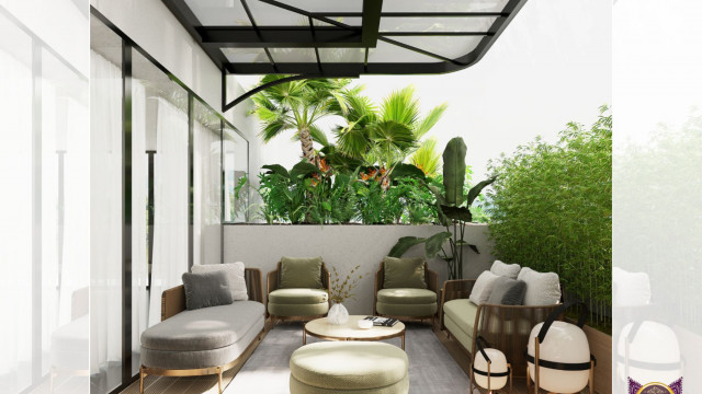 This picture shows an elegant living room with a modern grey and ivory color scheme. The walls are painted ivory, and the furniture is a combination of grey and ivory. There is a large comfortable sectional couch, two matching armchairs, a round ottoman, and a low coffee table. On the walls are two large abstract pieces of art, and two iron scones provide additional lighting. The space is decorated with a variety of colorful throw pillows and a black and white striped area rug to tie everything together.