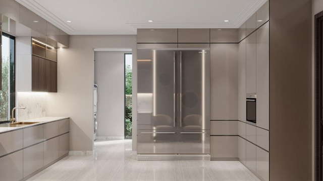 A modern kitchen with a white marble countertop and backsplash, dark cabinets, and stainless-steel appliances.