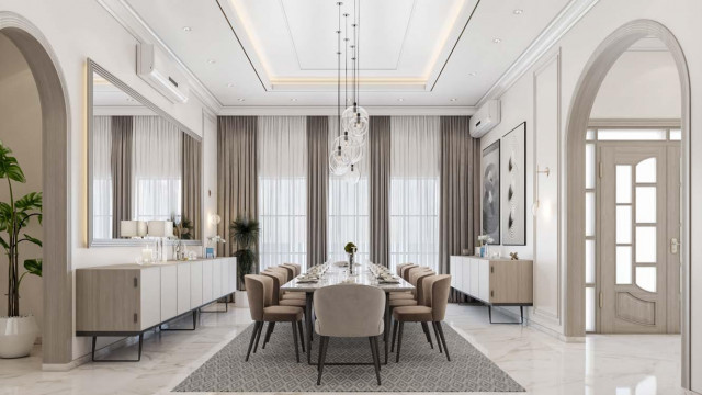 Modern luxury interior design with white walls and flooring, marble columns, crystal chandeliers, and velvet seating.