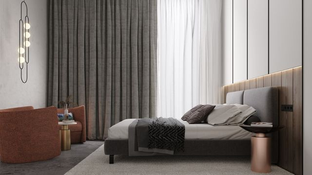 Modern living room with cream-colored walls, ceiling, and furniture, featuring a white stone fireplace, luxurious furniture, accent lighting, and a patterned rug.