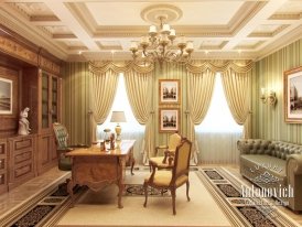 This is an image of a luxurious living room. It features an ornate white sofa with a plush blanket and colorful pillows, a luxurious round coffee table with gold accents, two elegant armchairs upholstered in a floral pattern in shades of cream and green, a beautiful glass chandelier with a pink tint, and a sophisticated area rug in a light grey pattern. The walls are covered in a light brown wall paper and adorned with artwork and sconces.