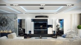 This picture shows an interior design of a modern home with luxe accents. It features a white marble fireplace and gold-framed mirror mounted above it, two beige sofas arranged around a round coffee table, and a large white chandelier hung from the ceiling. It also has a built-in bar with silver and black shelving behind the sofa, and a wall of glass windows that has a view of the landscaped terrace outside.