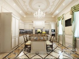 The picture shows a luxurious living space with a white marble floor, a grey sectional sofa, and two matching armchairs. There is a white wall with a decorative mirror, sconces, and two glass cabinets on either side. The walls are also decorated with gold wall accents and there is a large fireplace in the corner of the room. A round glass coffee table sits in front of the sofa and there are several plants adding greenery to the décor.