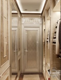 This picture shows a luxurious bathroom with a black and white marble floor and accent wall. The bathroom features two built-in vanities with grey marble counter tops and chrome faucets, large mirrors, and a built-in shower with a glass divider and a rainfall style showerhead. A large soaking tub is featured in the center of the room with a view of the outdoors and city skyline. Finally, luxurious wood cabinetry completes the look and provides additional storage.