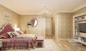 This picture shows a luxurious staircase leading up to a second story of a house. The staircase is made from marble and is curved in an elegant, sweeping pattern. The banister is silver and has a detailed pattern along the edges. A crystal chandelier hangs from the high ceiling, illuminating the area with a soft light. In the background there is a beautifully decorated foyer with two doors leading out to the outside.