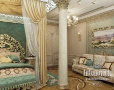 An elegant, stucco-style room with marble flooring and a golden sofa along the walls.