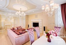 An incredible grand foyer of a luxury modern villa, with intricate details in its opulent design and large chandelier.