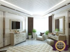 Sophisticated and luxurious classic bedroom with a stylish bed, ornamental details, and elegant furniture.