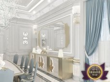 Interior design of a modern luxury villa with elements of classical style: luxurious chandelier, exquisite furniture and marble floor.