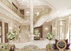 A modern reception area with a long counter and two graceful chandeliers, textured walls, and a view window.