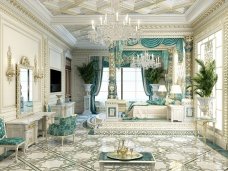 This picture shows a luxury bedroom interior design.The room features an ornate canopy bed with a white headboard, luxurious velvet upholstery, and a gold trimmed canopy. The walls feature a textured wallpaper in hues of light green, gold and cream, complimented by white and gold trim. Additional elements in the room include a crystal chandelier, a white shag rug, and an upholstered armchair.