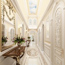 This picture shows a luxurious kitchen with a marble countertop and white cabinets. The center island is topped with another marble countertop, and is completed with built-in appliances such as a wine cooler and refrigerator. There are two pendant lamps hanging from the ceiling, adding to the sophisticated look of the room.