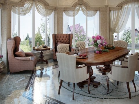 This picture shows a luxurious living room with a curved white sofa, two matching accent chairs, a glass top coffee table, and intricate wall decor. The walls are painted a warm beige color and have ornate light fixtures hanging on them. The floor is covered in a light colored rug and the furniture is arranged in an elegant, symmetrical pattern.