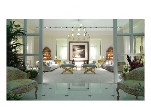 This picture shows a white four-poster bed with two tall upholstered headboards in the center, flanked by two teal nightstands with gold handles and crystal table lamps. In the foreground, you can see a large, patterned beige and brown rug and a white chair with a teal throw pillow.