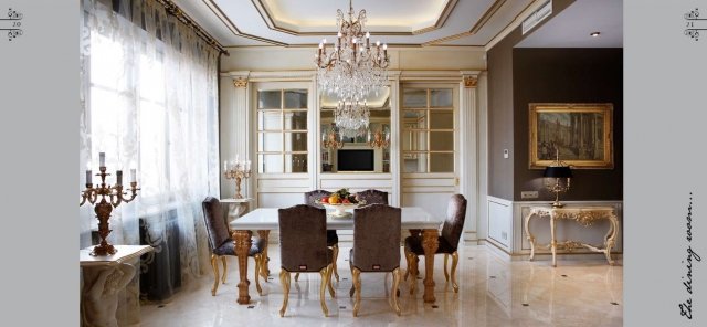 This picture shows a luxurious ornately designed living room, furnished with high end furniture. There is a plush light-colored area rug on the floor, a large ivory colored leather couch with two matching armchairs and a white marble fireplace. The walls are adorned with intricate moldings and large windows with light-colored curtains that let in natural light. At the center of the room is a wooden coffee table surrounded by potted plants and an elegant crystal chandelier hanging from the ceiling.