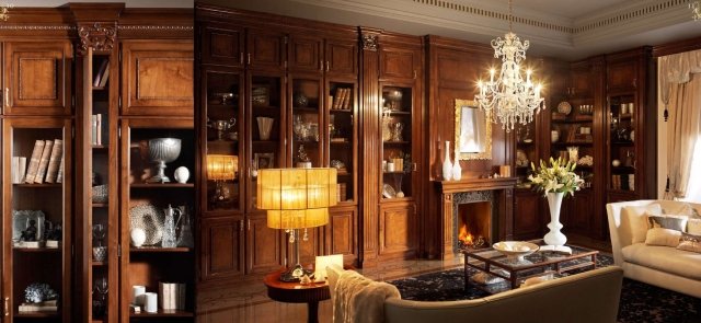 This picture shows a luxurious bedroom interior design with a grand king-sized bed, a plush armchair, and a high-end dresser. The walls are covered in a gold wallpaper, emphasizing the opulence of the space. The bed is upholstered in white, blue, and gold fabric, while the headboard has intricate carvings and gold accents. The armchair is styled in a classic vintage pattern and the dresser is also finished in a golden color. A large window allows plenty of natural light to enter the room, and a small chandelier hangs from